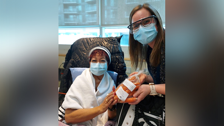 Dietitian Jodie Dupere hands out carrots to dialysis patient Leslie Ager at the Sheldon M. Chumir Health Centre.