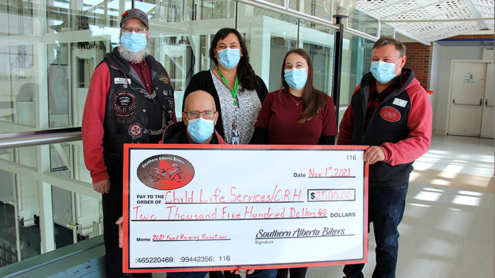 A ceremonial cheque presentation to fund pediatric supplies at Chinook Regional Hospital was attended by, from left: Harvey Kootse, community liaison, Southern Alberta Bikers association; Dallas Harty, association president; Jodie Anderson-de Boer and Brandi Emes, child life specialists; and Michael Fick, association vice-president.