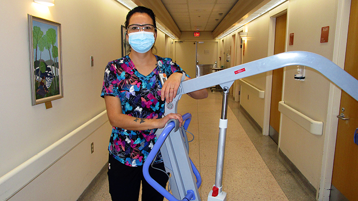 Marcella Friesen, a health care aide at Cold Lake Healthcare Centre, poses with one of two new lifts donated to the centre through community generosity and efforts of the Grand Centre Lions Club and the Cold Lake Medical Development Fund Society.