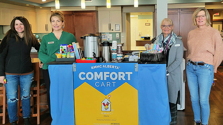 Together with Ronald McDonald House Charities Alberta and FortisAlberta, AHS celebrated the launch of a Comfort Cart, a new patient and family-centred initiative aimed at supporting families with children in care at Red Deer Regional Hospital Centre. Ronald McDonald House Charities’ Comfort Cart program is supported by FortisAlberta’s Community Investment programs, which will keep the cart well-supplied with convenience items such as coffee, snacks and games. Gathered for the launch are, from left: Paula Anderson, FortisAlberta; Jennifer Clermont, Ronald McDonald House Charities Alberta; Sandi Sebastian, AHS; Annica Ollewagen, Ronald McDonald House volunteer; and Dave Bomhof, FortisAlberta.