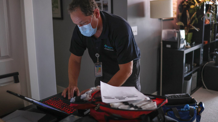 Trent Gahan, a community paramedic who supports the Complex Care Hub, visits a patient at home.