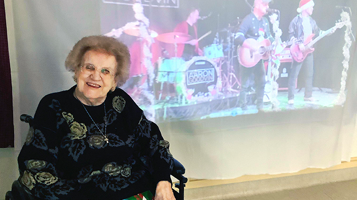 Anne Wrona enjoys some ‘screen time’ with country music star Aaron Goodvin at a virtual concert arranged for continuing care residents at Milk River Health Centre. Other performers included Duane Steele and Bobby Wills.