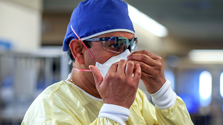 Orthopedic surgeon Dr. Debakanta Jena dons personal protective equipment before assisting in the care of COVID-19 patients. Jena has stepped up to support colleagues in acute care at Medicine Hat Regional Hospital.