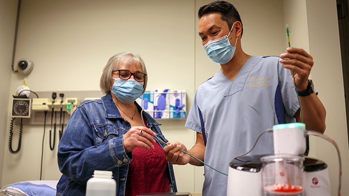 Brenda Crowell, left, was the first patient in Canada to undergo an embolectomy using the new CAT12 Lightning catheter as demonstrated by interventional radiologist Dr. Jason Wong. Dr. Wong and his team saved Brenda’s life with the device after she developed deadly blood clots from a COVID-19 infection in May, 2021.