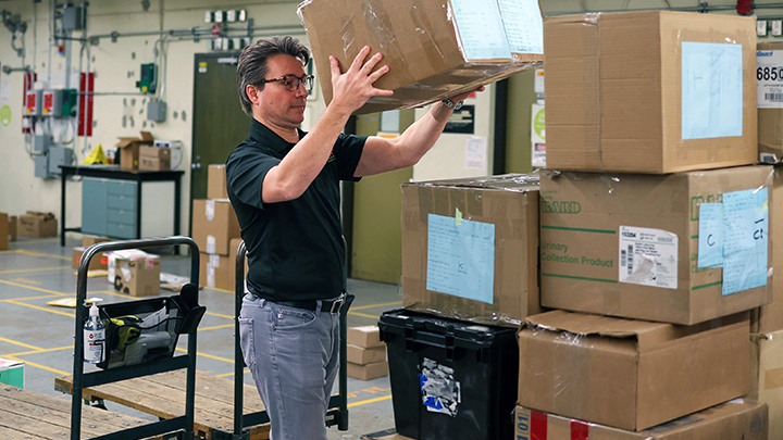 Dr. Paul Fedak, a cardiac surgeon at the Foothills Medical Centre, loads boxes of essential medical supplies on a pallet destined for the Heart Institute in Kyiv, Ukraine.