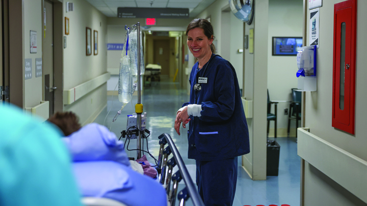 Nielsen smiles as a patient heads down the hallway. In this world, everyone knows her family. Her father, a family physician; her mother an ICU nurse; and her sister, now her colleague, also an ED nurse. She credits her them equally for who she is and how far she’s come – proud to walk in their footsteps.