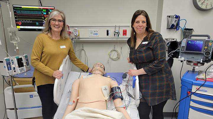 Nadine Terpstra, left, and Charlyn Stanley, simulation consultants with the eSIM program in Central Zone, pose with a mannequin they use to teach in various healthcare scenarios, at a recent open house for the eSIM program at Red Deer Regional Hospital Centre.