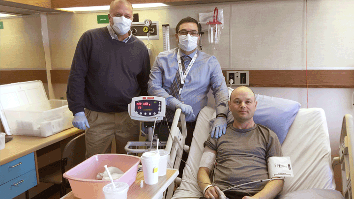 This photo, taken in 2017, shows study participant Darren Bidulka shortly after he received a transfusion of his modified stem cells. He’s shown here with research doctors Jeffrey Medin, left, and Aneal Khan.