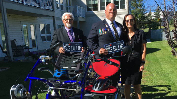 Robert Parmenter, left, and Pat Duggan (Royal Canadian Legion Fort McMurray Branch 165) and Lorna Ash (director of development, Northern Lights Health Foundation) show off a new custom-built, four-person adaptive e-bike. The e-bike, also known as “Big Blue”, has been used by AHS North Zone Public, Population and Indigenous Health and Seniors Health teams, in conjunction with community agencies since June.