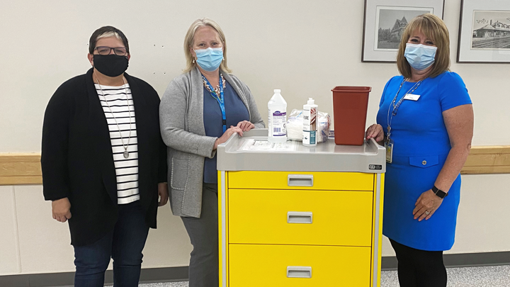 Richelle Belzerowski, Executive Director, Friends of the Red Deer Regional Hospital Centre, Kim Storey, Senior Operating Officer at the hospital and Tracy Reberger, Acute Care Manager, stand next to one of the isolation carts purchased in 2018 by the Friends. The carts store the personal protective equipment staff require on their rounds.