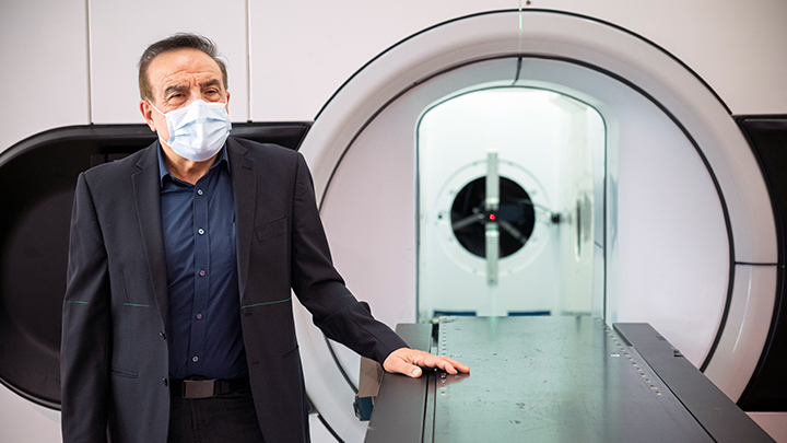 Medical physicist Dr. Gino Fallone poses with a Linac MR machine which combines two technologies — magnetic resonance imaging and X-ray radiation — to track and treat tumours in real time. Radiation is capable of destroying cancer, while MR provides increased visibility.