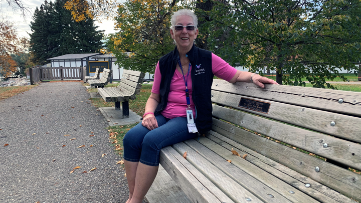 A 10-year volunteer at Chinook Regional Hospital, Rosemarie Gattiker sits on a bench dedicated to her late husband, Wayne, at Henderson Lake in Lethbridge.