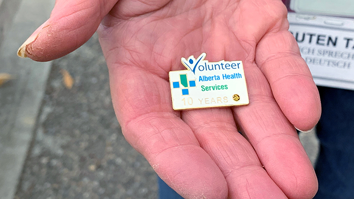 Rosemarie Gattiker holds her Alberta Health Services Volunteer pin that recognizes her 10 years of helping patients at Chinook Regional Hospital in Lethbridge.
