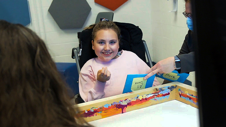 Olivia Terry is all smiles as she gets ready to paint a picture during her brain-computer interface appointment at the Glenrose.