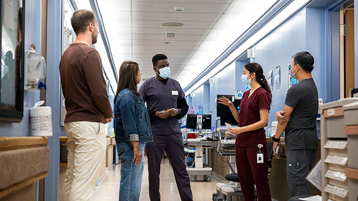 The Unit 3D team huddles to discuss patient care at the Glenrose Rehabilitation Hospital. From left are: Doran Walker, Debbie De Guzman, Idiris Bashiir, Kamaljot Mangat and Eric De Vera.