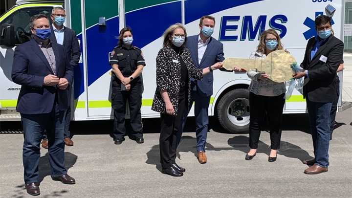 Senior Operating Officer Stacy Greening accepts the key to the new regional hospital in Grande Prairie from Health Minister Tyler Shandro, Grande Prairie MLA Tracy Allard and Infrastructure Minister Prasad Panda, while Premier Jason Kenney and Finance Minister Travis Toews look on.