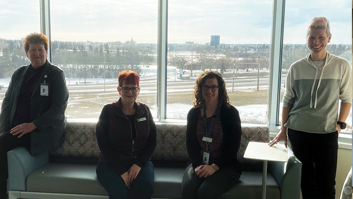 Rosemary Van Herk-Auger, left, Patient Care Director for the Grande Prairie Regional Hospital (GPRH), joins Wanda Johnson, President of the Grande Prairie Hospitals’ Auxiliary Association, Penny Kelln, Unit Manager for Women’s Health, and Candice Edey, Senior Operating Officer. The foursome are celebrating the addition of new sleeper coaches and overbed tables for the Labour and Delivery unit.