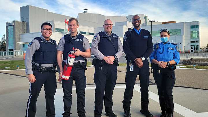 Members of the Protective Services C-Team at Rockyview General Hospital — Cedric Balazon, left, Christopher Dirk, Blaine Austin, Abass Ahmed and Mia Manina — worked quickly to prevent a grassfire from spreading to their community. (Absent from photo is Marcy Declerck, who also took part.)