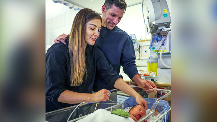 Darby Ewashina and Micah DeHenau look at their newborn son Loveland in the NICU at Rockyview General Hospital on March 28. Loveland is pictured with a flannel heart sewn for him by volunteers as part of the Heart Scents program.