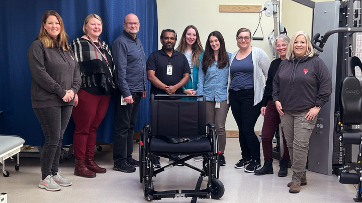 Kari Leiper, executive director (far left), and Lynne Colaris, board director with Hearts for Healthcare (far right), join members of the Cold Lake Community Health Services team — from left: Sharon Winik, Todd Farrell, Mujahid Thaha Mohamed Abdul Kader, Madison Bekkers, Shelby Pollock, Jana Dugas and Candice Stewart) — in celebrating the arrival of a new bariatric wheelchair funded by community donations.