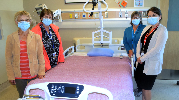 Standing alongside the new expandable double bed for palliative care at High Prairie Health Complex are, from left: Ione Perry, president, High Prairie Palliative Care Society; Margaret Kruger, president, High Prairie Ladies Health Care Auxiliary; Karen Zelman (AHS volunteer coordinator; and Samantha Nemec, care manager.