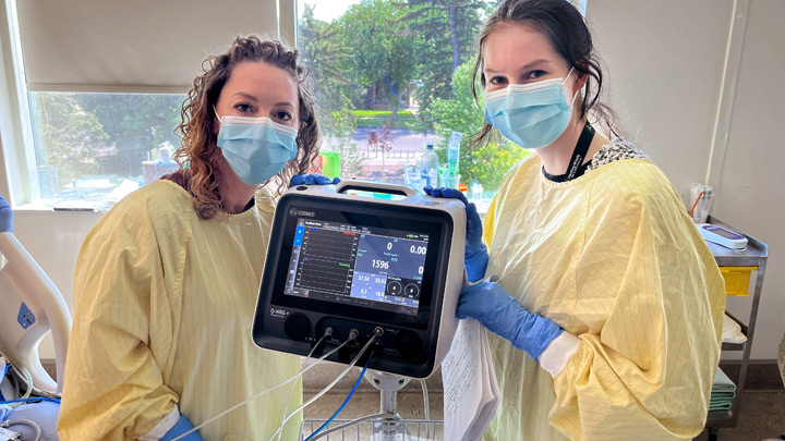 ICU registered dietitians Emily Stein and Lauren Tweel are pictured using the indirect calorimeter on a patient in the CRH’s critical care unit.