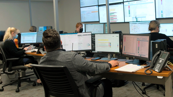 The Integrated Operations Centre team reviews real-time data on screens to determine where patients can get the right care, as fast as possible.