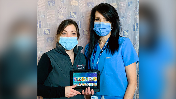 Registered Nurses Kendra Morrison and Ronnie Biletsky showcase one of the new child-friendly tablets in the Emergency Department of the Red Deer Regional Hospital Centre. Generous donors funded the tablets through the Red Deer Regional Health Foundation.
