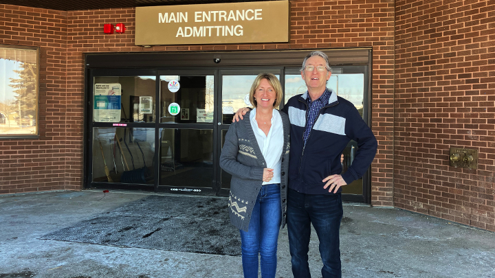 Lisa Sparks, manager, Lac La Biche & Smoky Lake Sites for AHS, joins Allan Sinclair, chair, Lac La Biche Regional Health Foundation, in front of the William J. Cadzow – Lac La Biche Healthcare Centre.