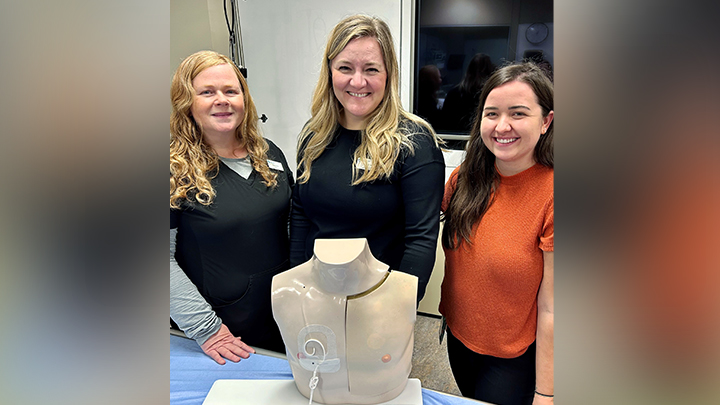Some of the Alberta Children’s Hospital staff involved in the central-line improvement project are, from left: Clinical Nurse Educators Marsha Bucsis and Ashley McFetridge, and Registered Nurse Kelsey Frache,  who are shown here with Chester, their training-simulation mannequin.