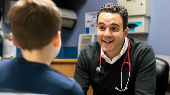 Dr. Michael Khoury enthusiastically gets down to business with his young patient Ryan Heathcote.