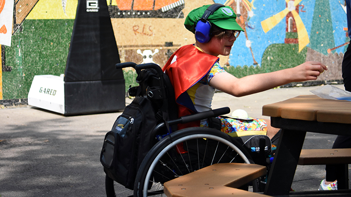 Maverick Schulz, 9, collects coins off a table as part of a Mario Kart wheelchair race at Wheelie Camp at the Glenrose Rehabilitation Hospital. The experience empowers differently-abled kids to have fun and learn new skills on field trips into the community.