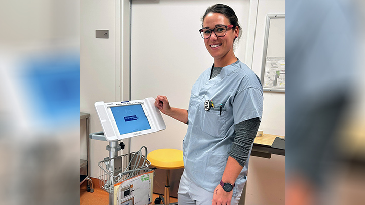 Registered Nurse Mel Stelfox poses with an Interpreter on Wheels unit at Chinook Regional Hospital in Lethbridge.
