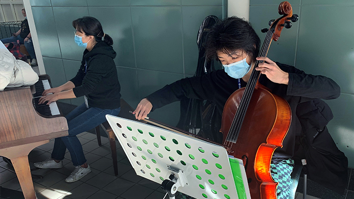 Sebin Cho plays the cello while his mom and classical music teacher Youngim Song performs on the piano. They’re accompanied by his violinist sister Soobin Cho (not shown).