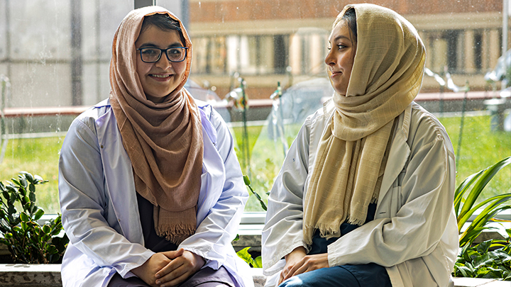 Edmonton-raised sisters Nabeela Khan, left, and Laila Naheed received their medical degree from Pakistan in 2021 and now work as associate physicians at the University of Alberta Hospital.