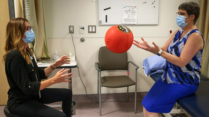 Physiotherapist Jacquie Townsend, left, plays catch with Vanessa Jollimore at South Health Campus in Calgary as part of Jollimore’s rehab.