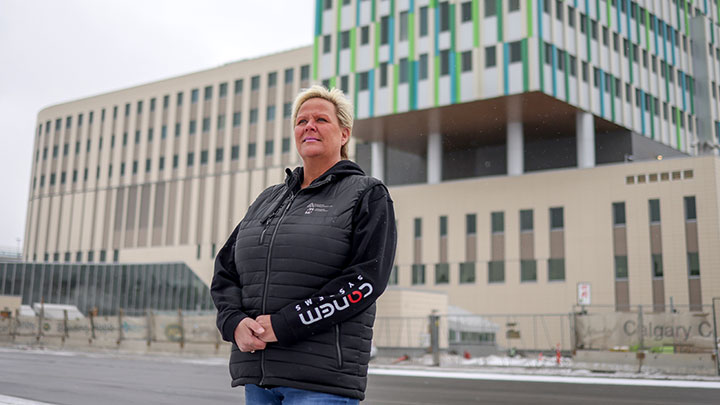 Sher Hawkins snaps a selfie as the new Calgary Cancer Centre takes shape behind her. “I’ve watched and participated first-hand in building this new world-class cancer centre,” she says. “Now when I look at this big, beautiful building, I see me. I see my journey. I see all of us survivors.”