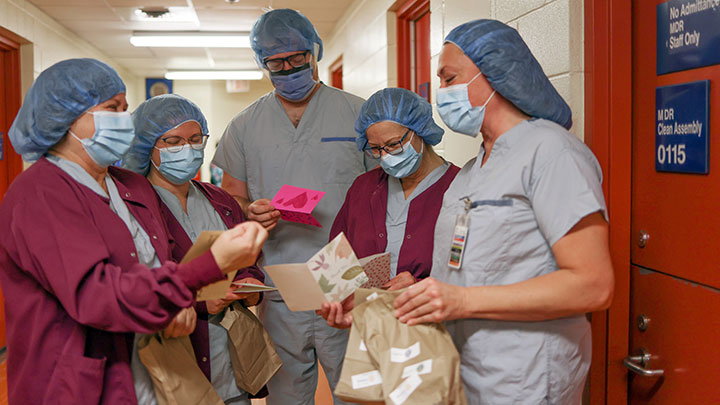 Medical Device Processing employees (left to right) Corina Whyke, Becky Davis, Randy Nelson, Mary Wood and Kim Moore look over their care packages at the Olds Hospital and Care Centre on November 2.