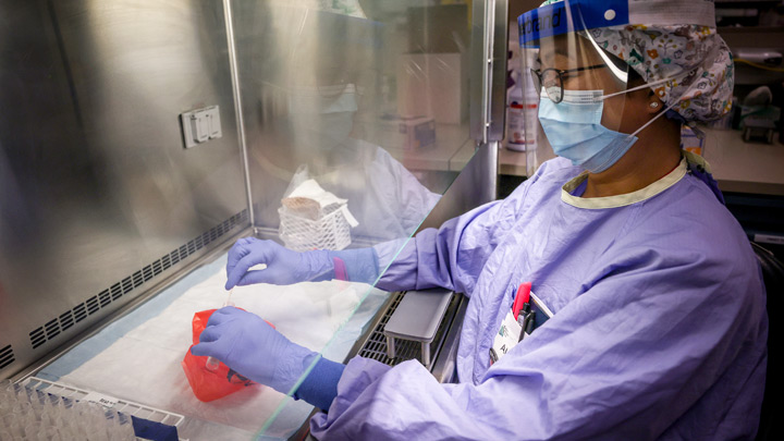 Lab technologist  Alma Hinola tests COVID-19 samples at Calgary’s South Health Campus.