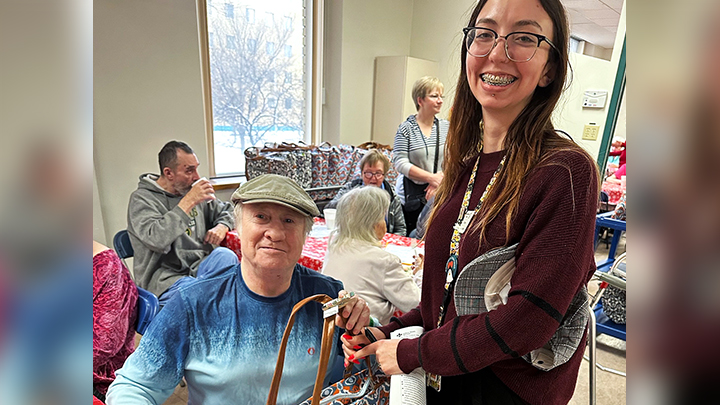 Thanks to a generous donation from Operation Friendship Seniors Society, social worker Sydney Gorman and her colleagues on Unit 18 at the Royal Alexandra Hospital handed out gifts to all patients on the unit, like Ian Pye, shown here with a special bag of sweet treats, socks, and hand-knit items.