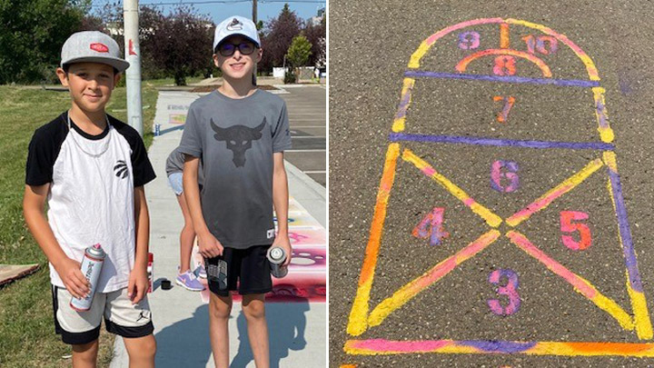 Channing Richer and Karsen Varty stencil games on Red Deer pathways as part of a youth initiative to spread kindness and build self-esteem.