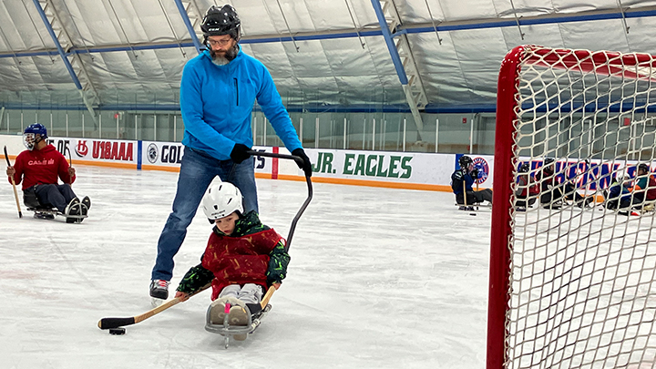Kassian Senneker and his grandfather Chris Haney take a shot on net.