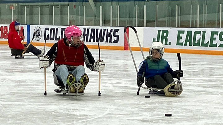 Oliver and Josh Harker take to the ice at the Nicholas Sheran Arena, practising para ice hockey with AHS Therapeutic Recreation. Participants range in age from 6 to 60 for this family-friendly activity, where all can enjoy an equal playing field. 