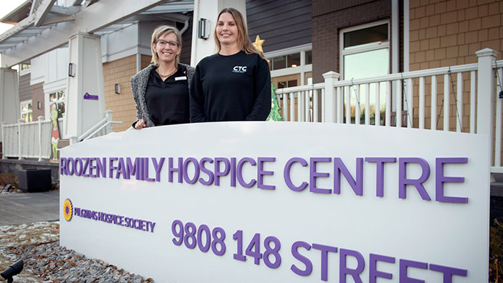 Pilgrims Hospice Society’s Lana Crawford, left, and AHS Comprehensive Tissue Centre’s Candice Bohonis pose in front of the Roozen Family Hospice Centre.