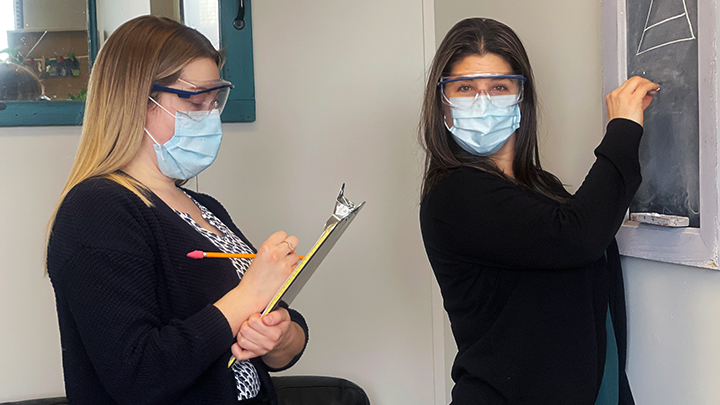 Practicum student Kristyn Nelson, left, takes notes as mental health therapist Kristine Crossland offers up some instruction in Bonnyville.