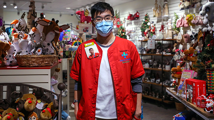 READY volunteer Julius Ho strikes a pose during a shift at Emily’s Window, the Red Thread gift shop at the Alberta Children’s Hospital.