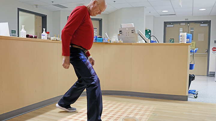 Grant Gordon stomps on virtual moles projected onto the floor while working to regain his mobility using the new Tovertafel unit at Red Deer Regional Health Centre.