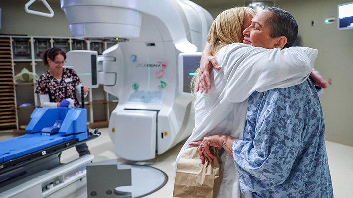 Renee Johnson, right, hugs Stacey Allan, a radiation therapist, following one her radiation treatments for breast cancer at the Tom Baker Cancer Centre.