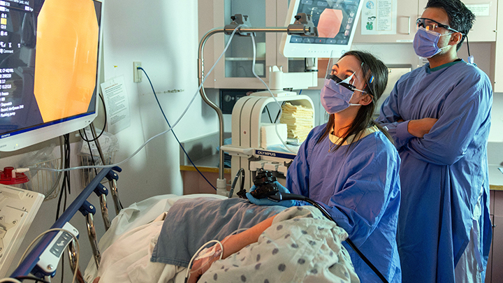 With the guidance of gastroenterologist Dr. Mandeep Sandhu, Dr. Lindey Felske performs a colonoscopy procedure at the Sturgeon Community Hospital.