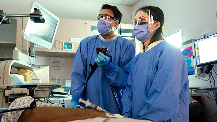 Dr. Mandeep Sandhu shows Dr. Lindey Felske a different way to hold and advance the endoscope during a gastroscopy procedure at the Sturgeon Community Hospital.